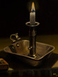 Chamberstick with burning candle